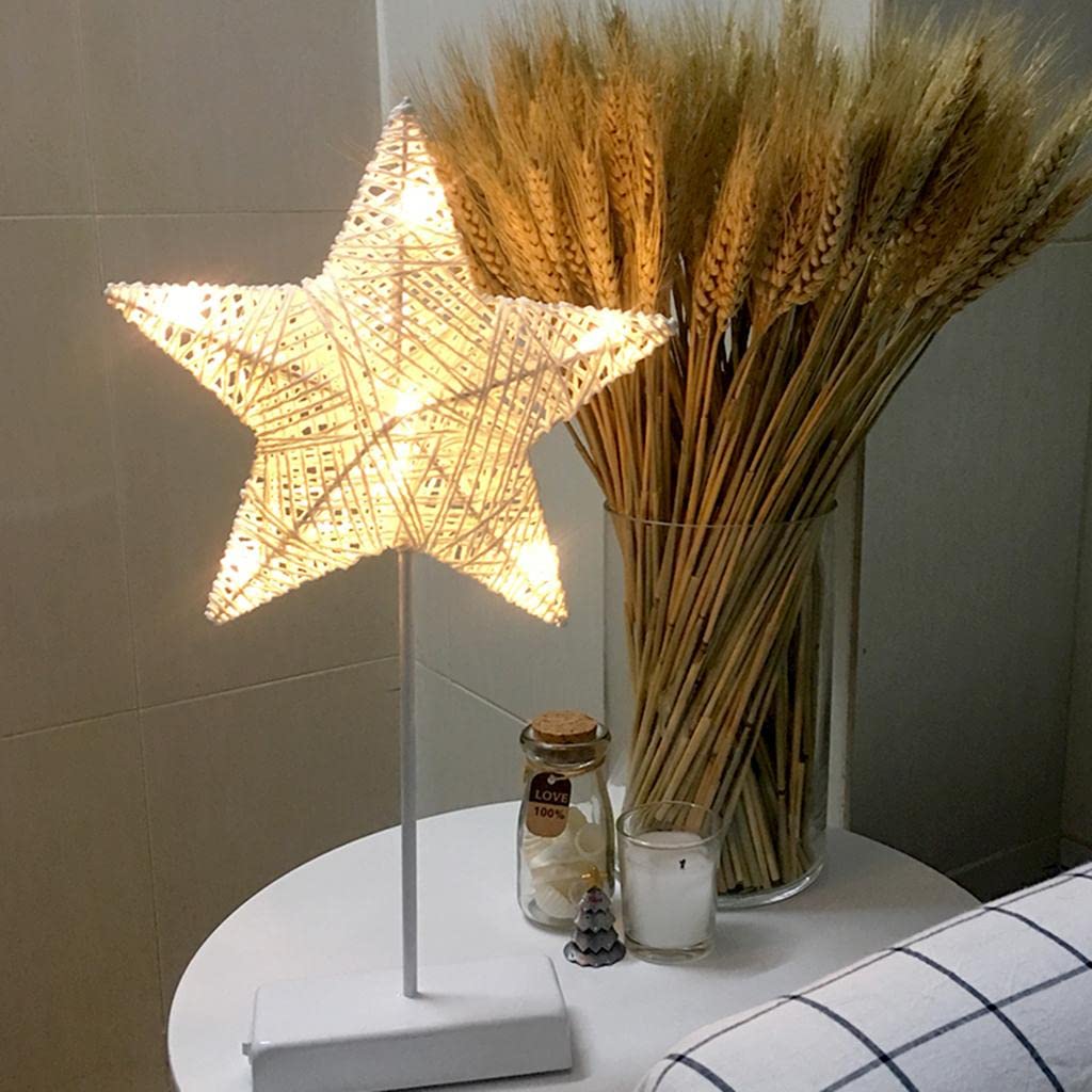A LED Star Table Lamp Decorative Night Light is Placed on a Table Along with Other Decor Items.