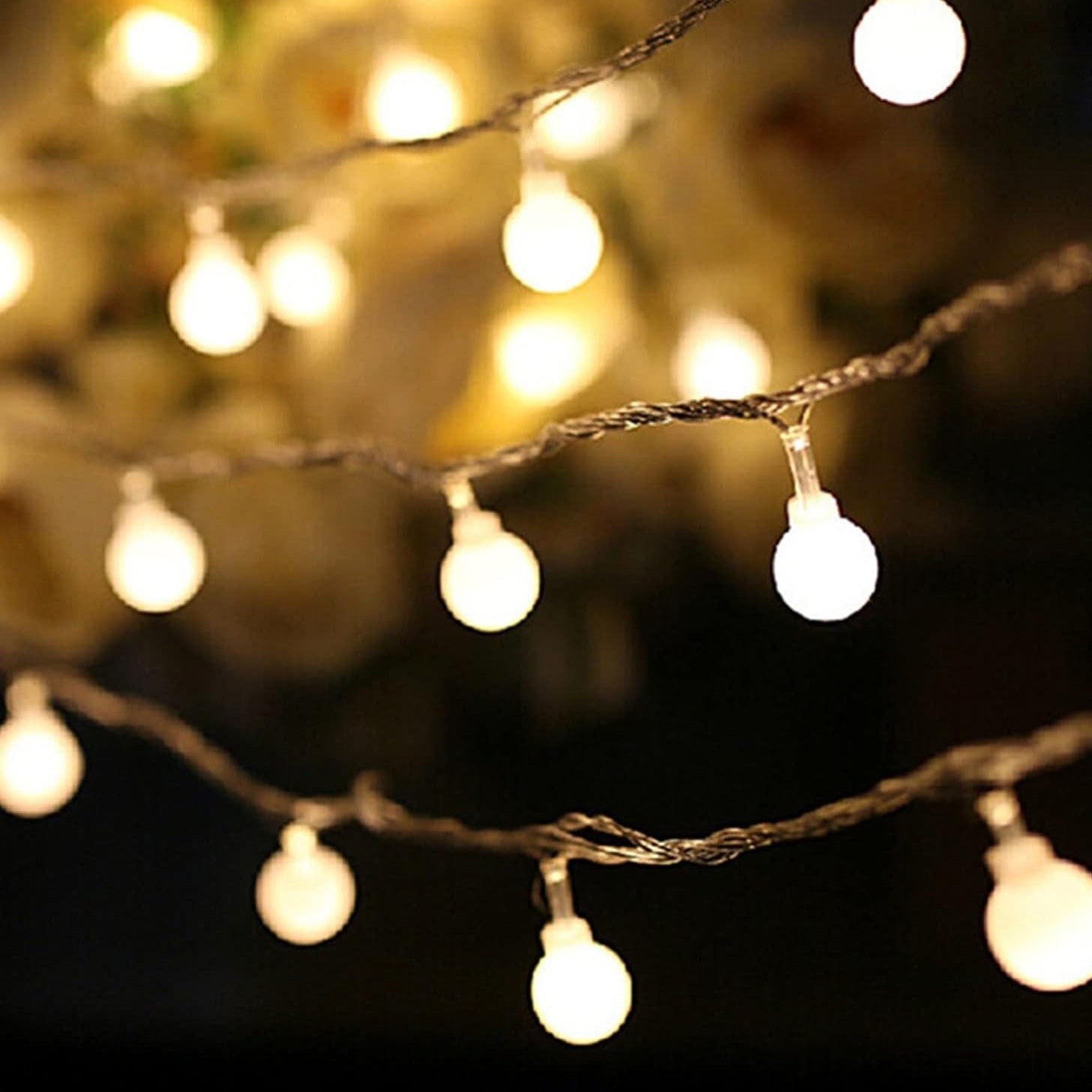 String of lights with round bulbs on a dark background