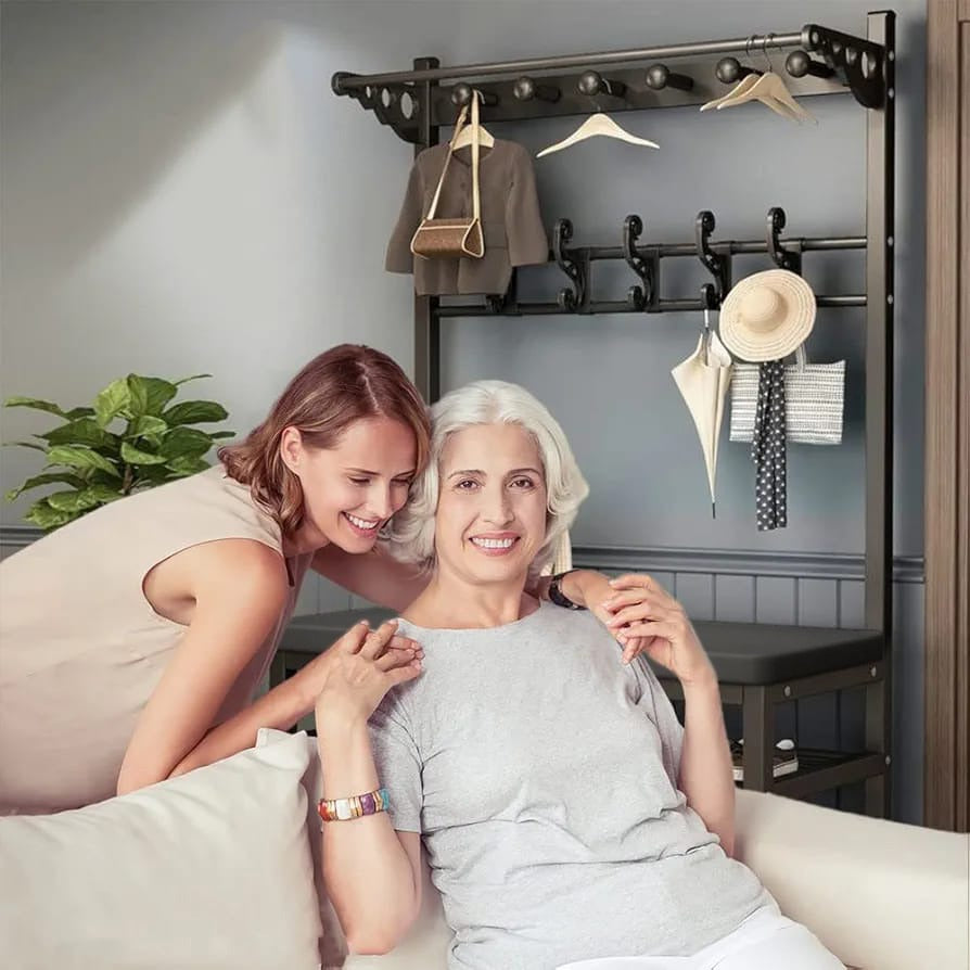 Large Coat Stand Hanger with Shoe Rack Bench Having Shoes and Dresses Are Organized Where Grandma and Daughter are Sitting Next to it.