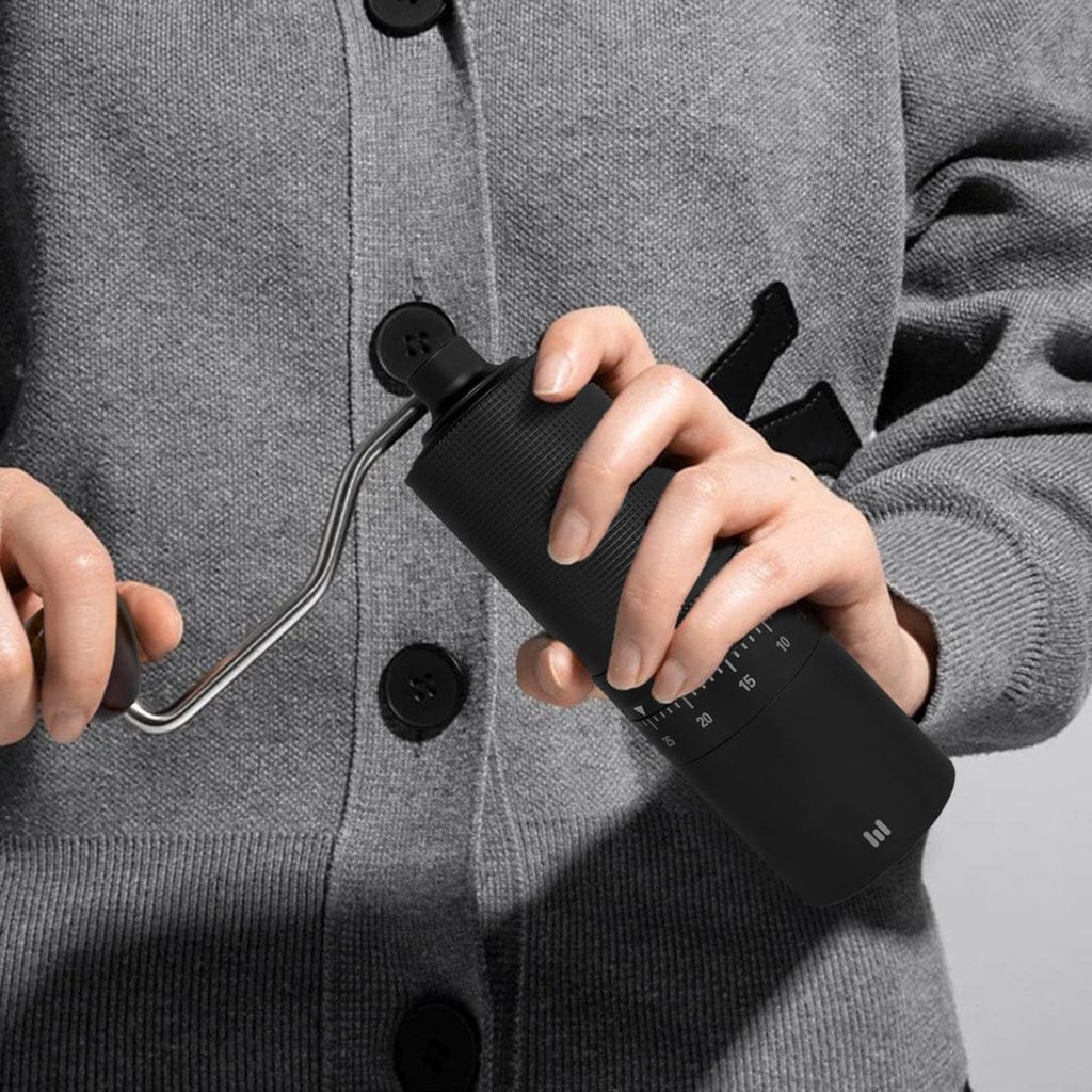 A Person is Holding Macnoa MacGrind Craft - Manual Hand Coffee Bean Grinder.