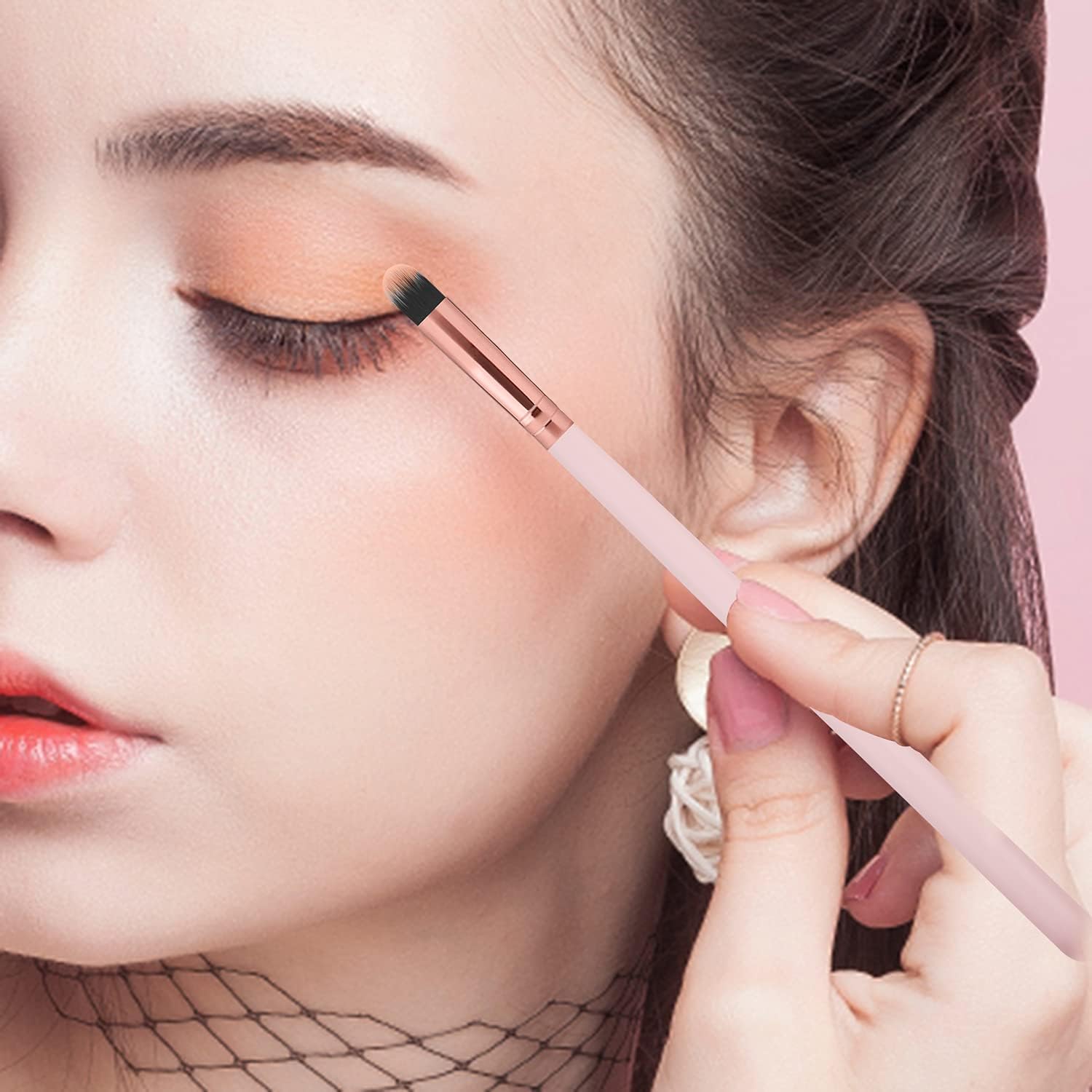 A girl is using a 16-Piece Makeup Brushes Set Kit with Premium Synthetic Bristles and an Eyebrow Razor