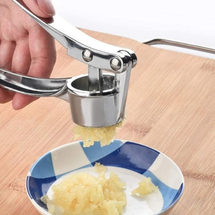 A Person is Crushing Garlic Using Manual Lemon Squeezer & Stainless Steel Ginger Garlic Press.
