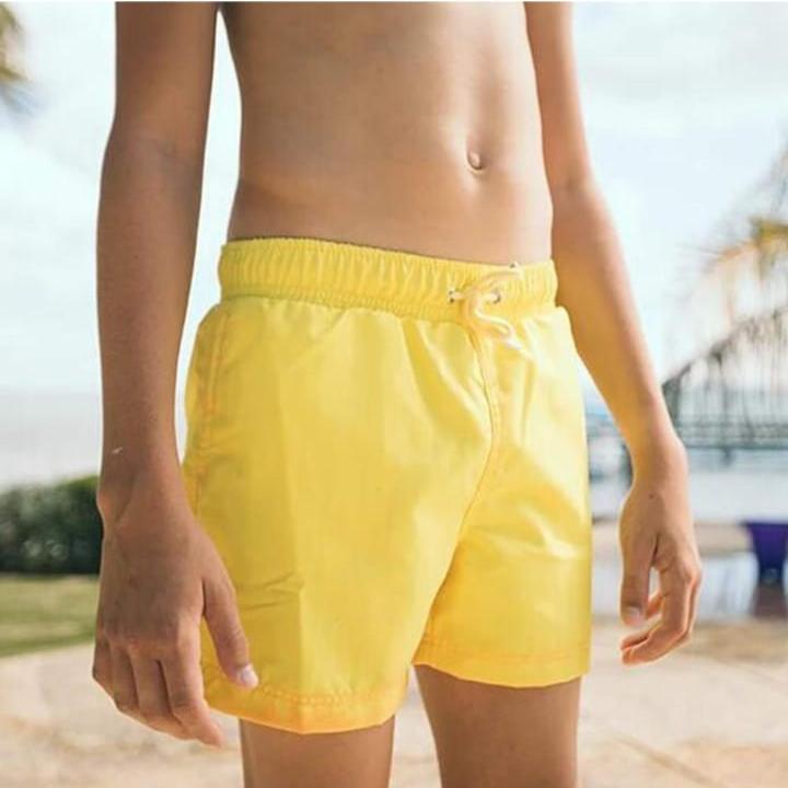 A Person is Wearing Men Color Changing Beach Shorts.