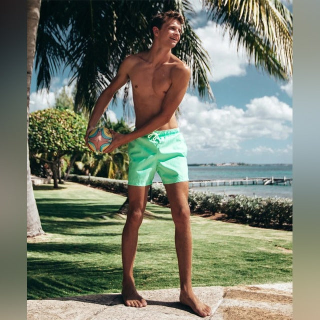 A Person is Wearing Men Color Changing Beach Shorts.