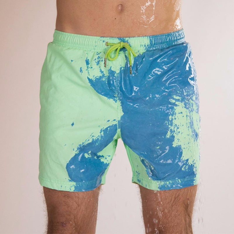 A Person is Wearing Men Color Changing Beach Shorts in Green Color.
