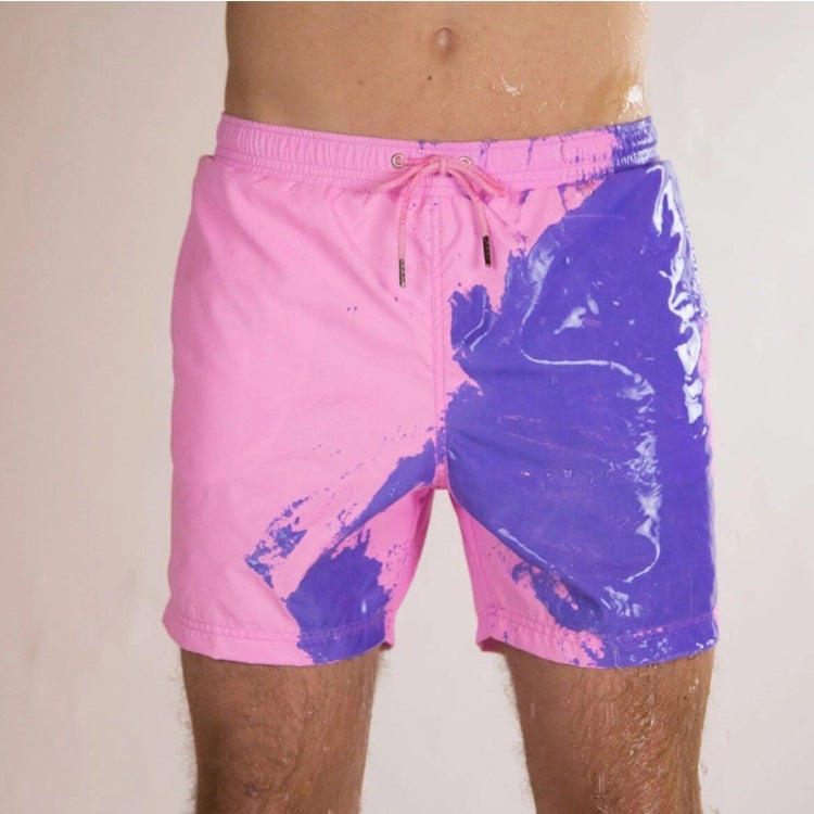 A Person is Wearing Men Color Changing Beach Shorts in Pink Color.