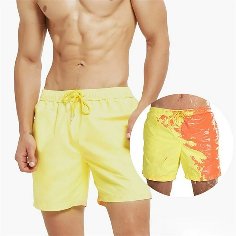 A Person is Wearing Men Color Changing Beach Shorts in Yellow Color.