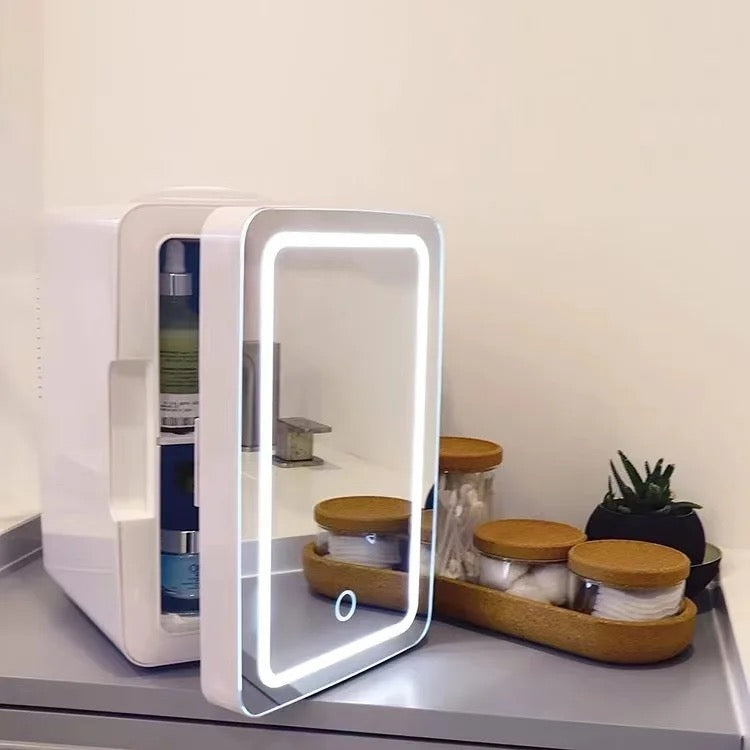 Mini Multifunction Cosmetic Refrigerator With Mirror is Placed On a Table.