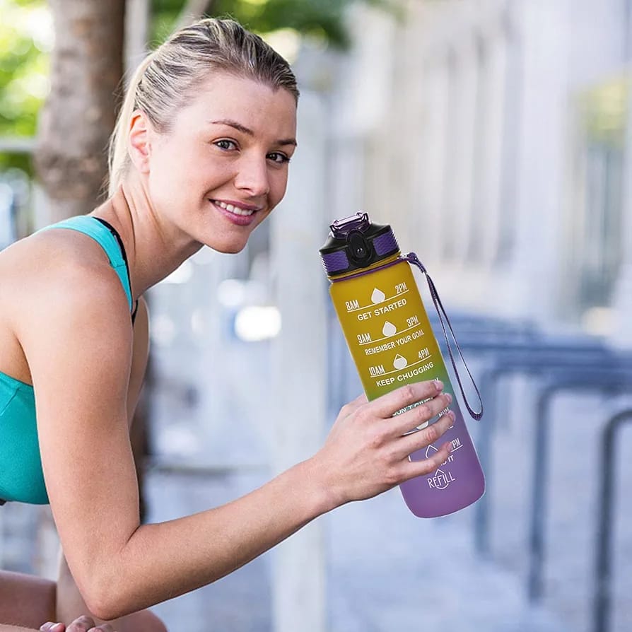 A Women is Holding Motivational Drinking Water Bottle.