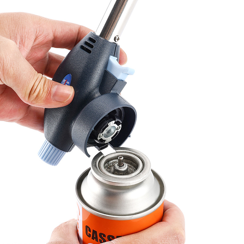 A Person is Fixing Multi-Purpose Butane Torch Flame Gun on to Gas Canister.