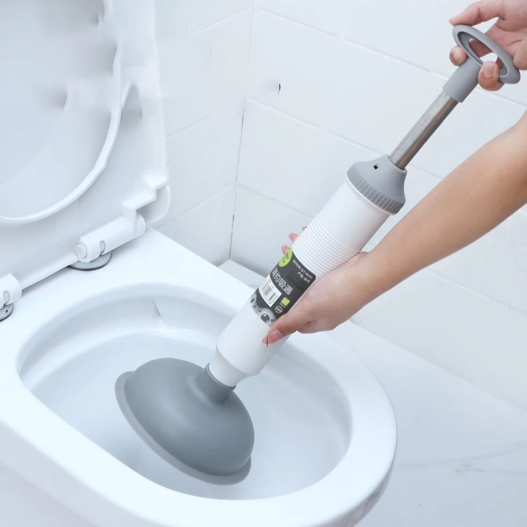 A Person is Unclogging the Closet Using Vacuum Type Multi-Purpose Pipeline Unclogger.