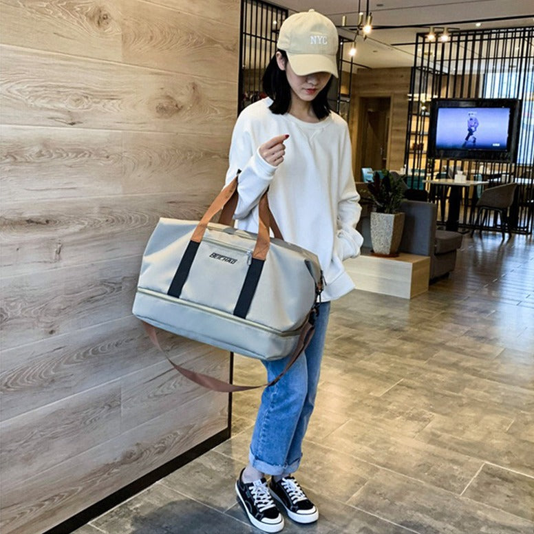 A Girl is Holding Multi-functional Fashion Fitness Travel Duffle Bag.