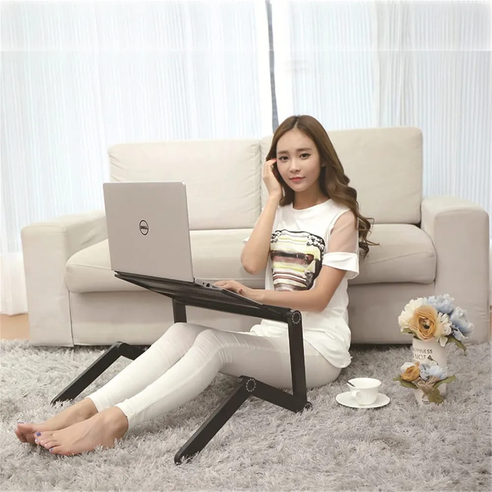 A Wmen is Using Laptop By Placing it On Multi-functional Laptop Holder Stand.