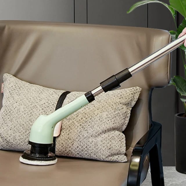 Someone cleaning a sofa using the 9-in-1 Multifunctional Electric Cleaning Brush