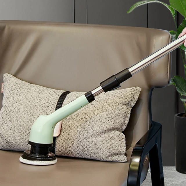 Someone cleaning a sofa using the  9-in-1 Multifunctional Electric Cleaning Brush