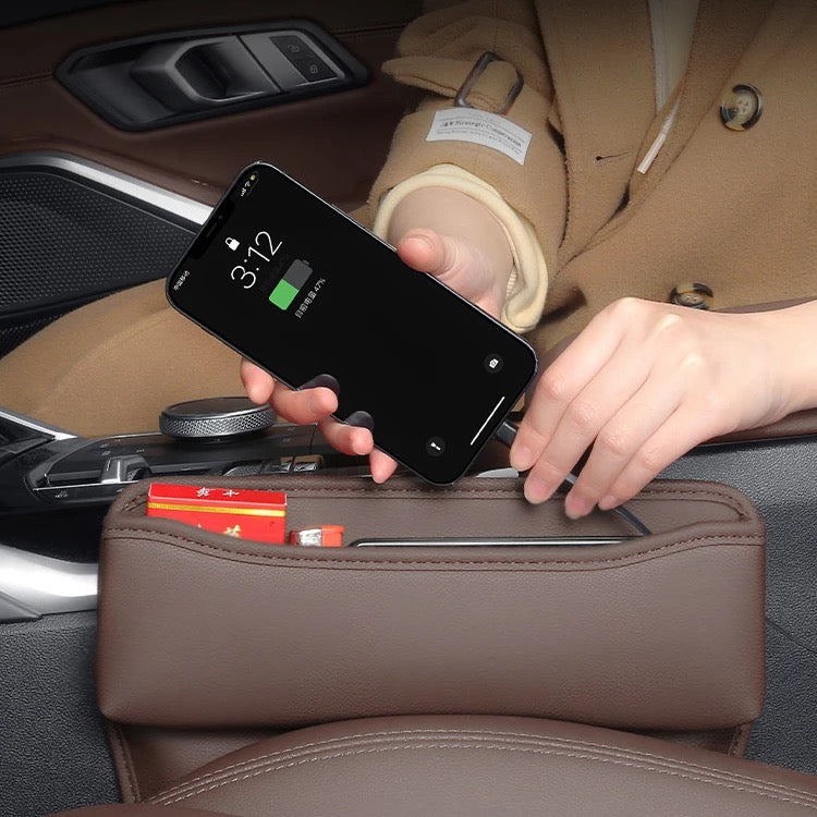 someone charging his phone with help of Car Seat Gap Storage Box Organizer
