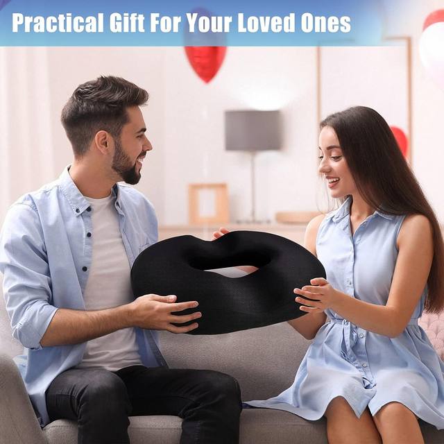 A man and a girl holding the Donut Pillow Seat Cushion