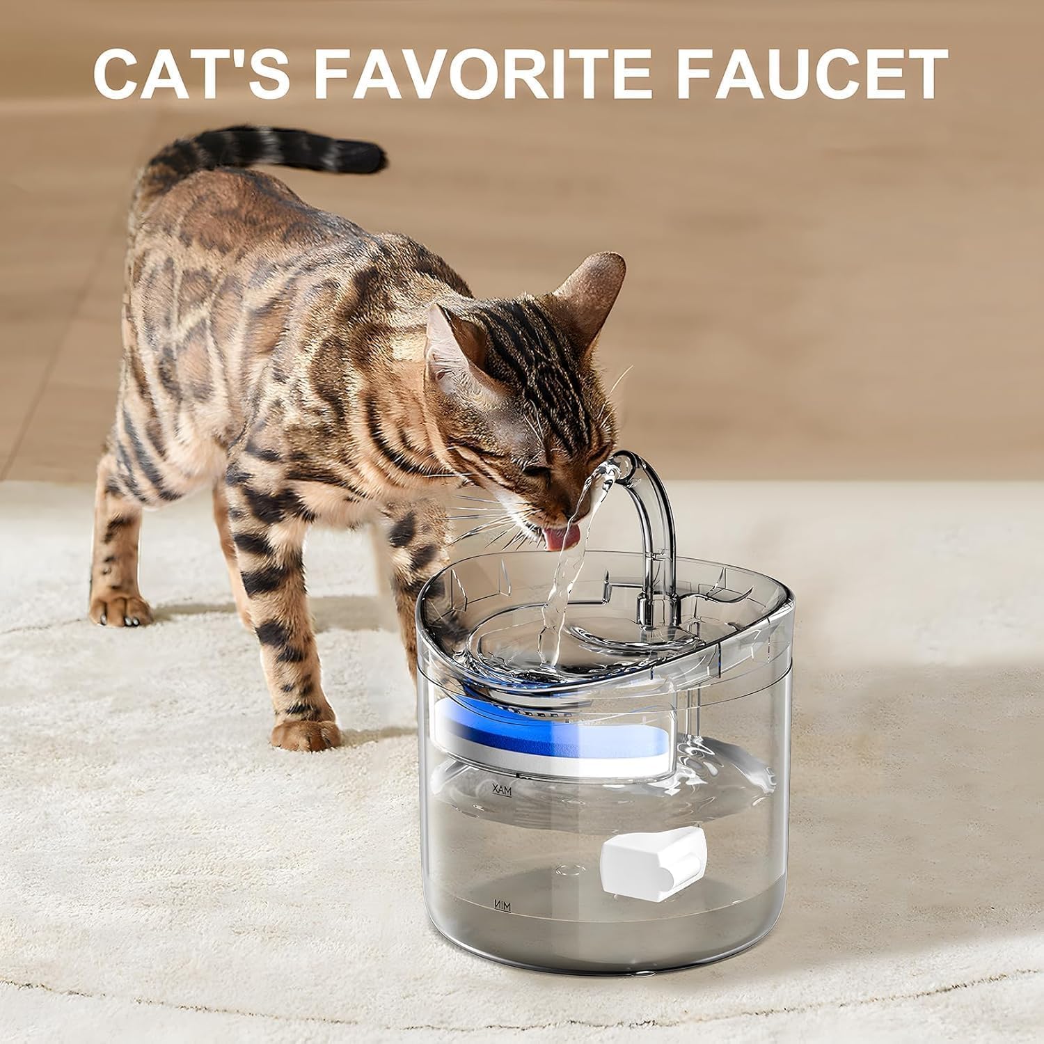 A cat drinking water from a transparent pet water fountain placed on a wooden floor, with a continuous stream flowing from a spout, showing the filtered water system and fill level markings.
