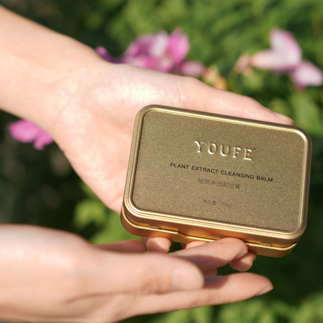 Someone is Holding Plant Extract Cleansing Balm.