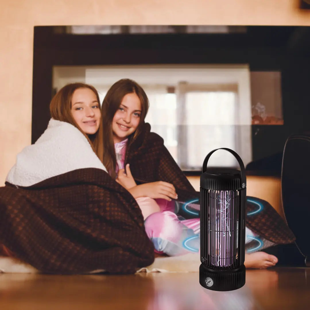 Two people sitting together under a blanket with a Porodo Portable Mosquito Zapper