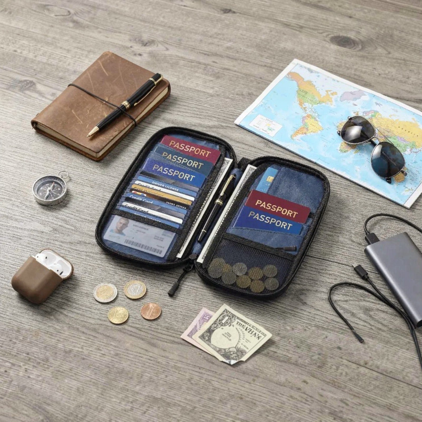 Porodo Milano Smart Passport Holder and cards on a wooden surface with a map and travel items.