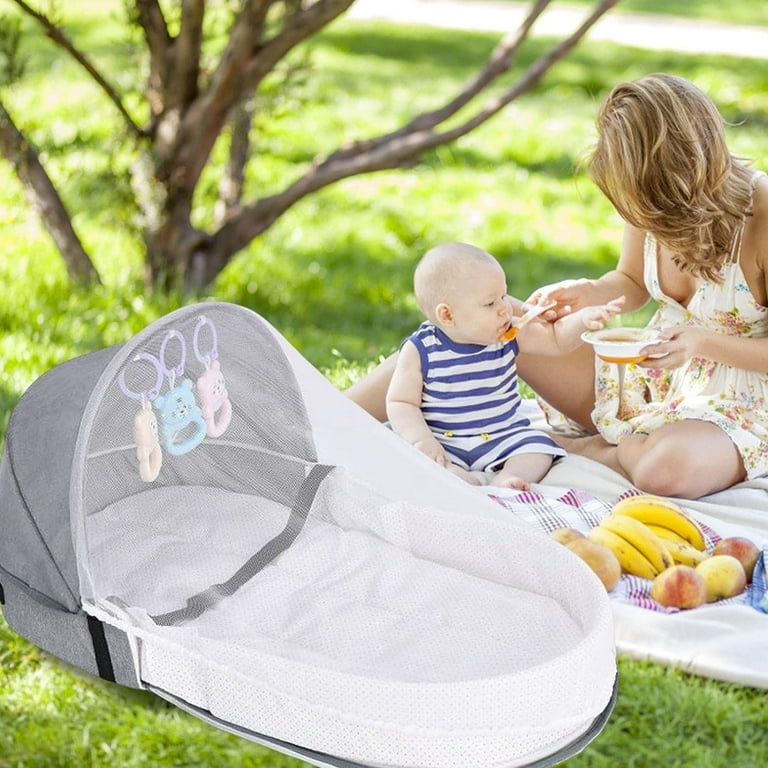A Mother and Baby is Carried Portable Baby Bed to Picnic Area.