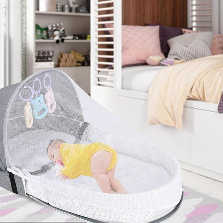 A Baby is Sleeping On Portable Baby Bed.