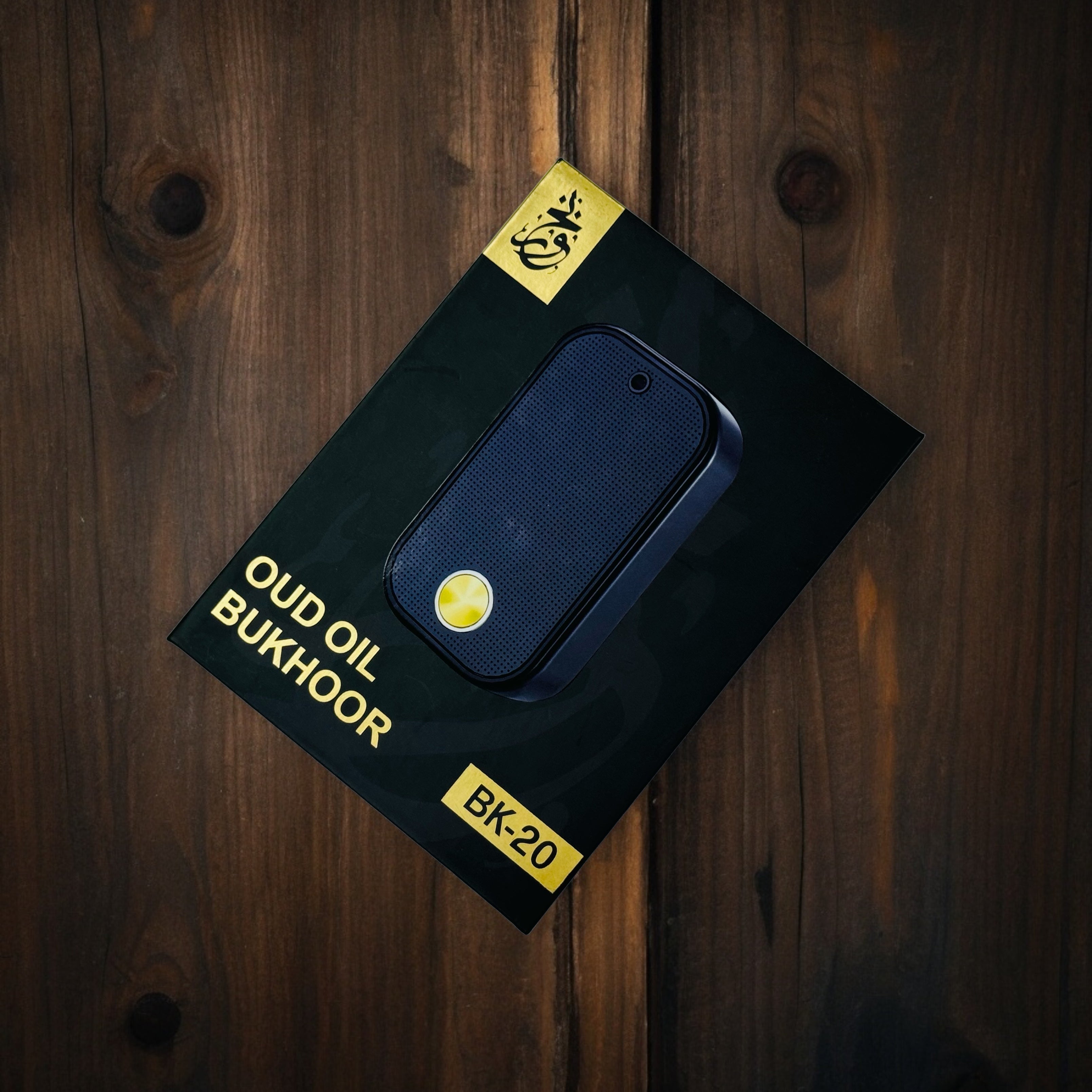 Portable Electric Oud Oil Bukhoor Burner on a dark wooden surface