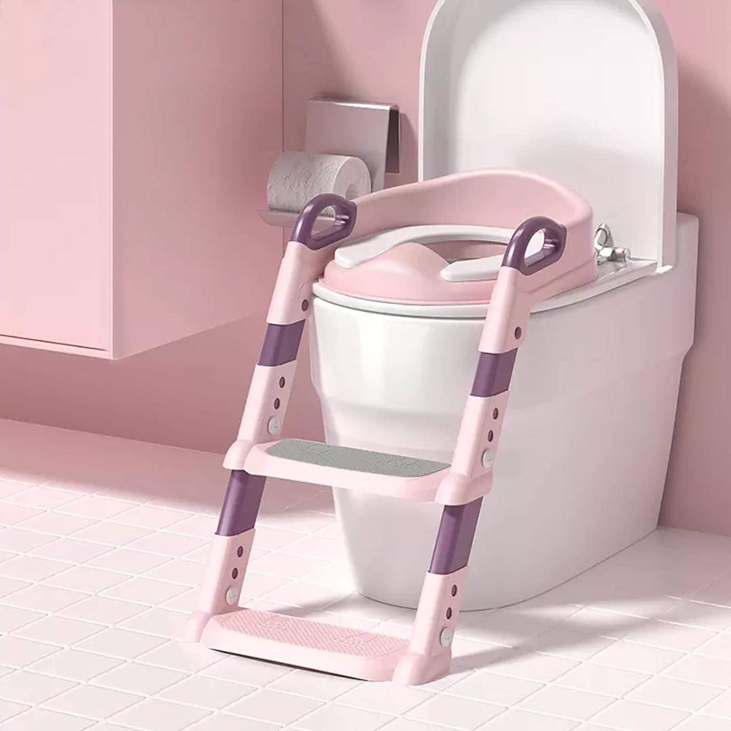 Pink and purple Toilet Potty Trainer Seat with ladder attached to a toilet in a bathroom.