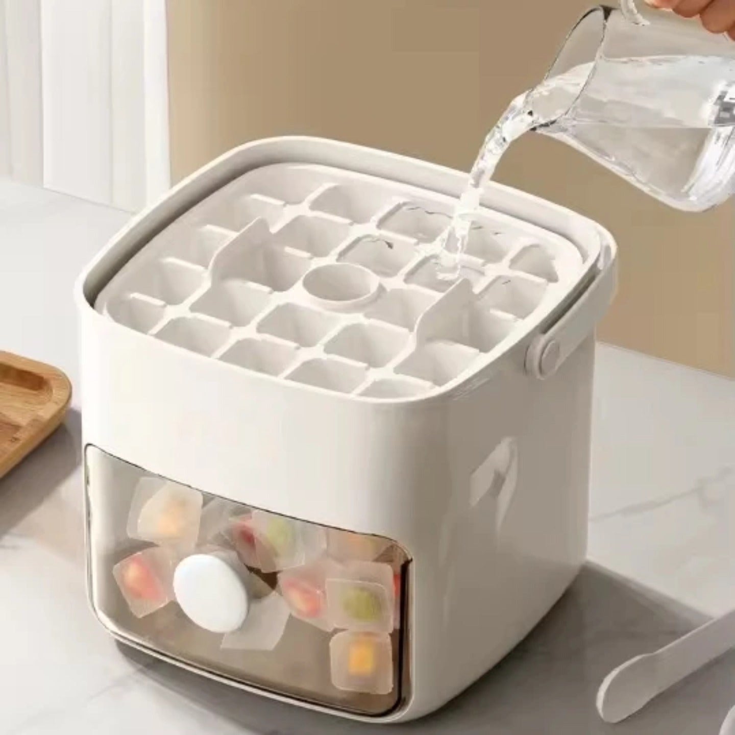 Someone is pouring water in to Press-Type Ice Cube Maker.