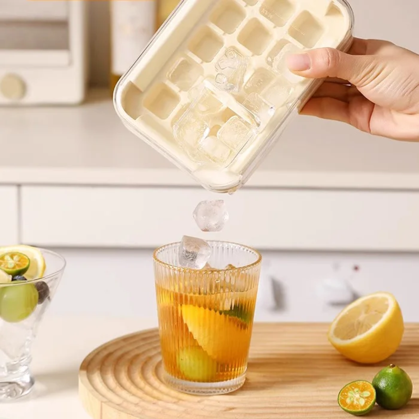 A Person is Pouring Ice from Press Type Ice Cube Making Tray Mold to his Drink.