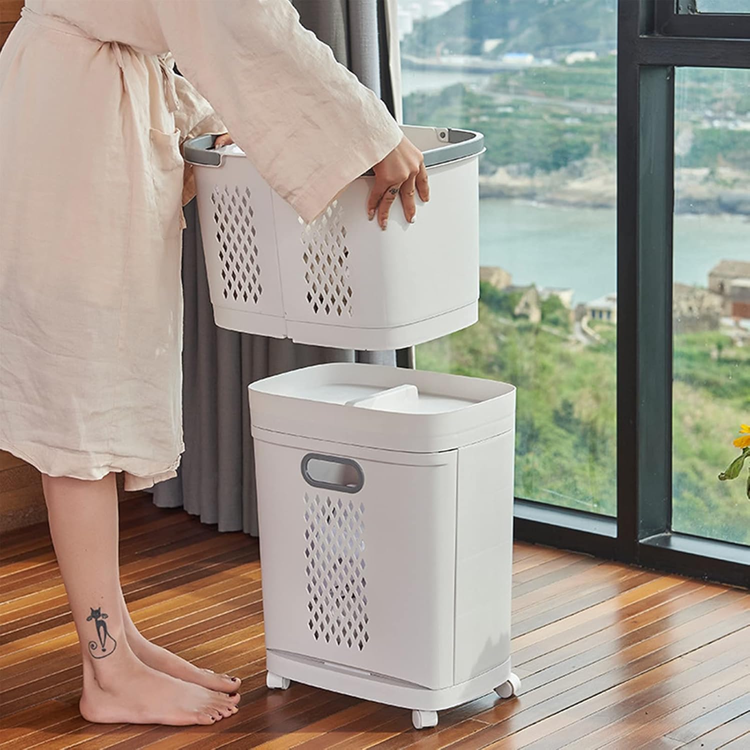 A lady is standing next to the laundry basket, showing the drawer being pulled out.