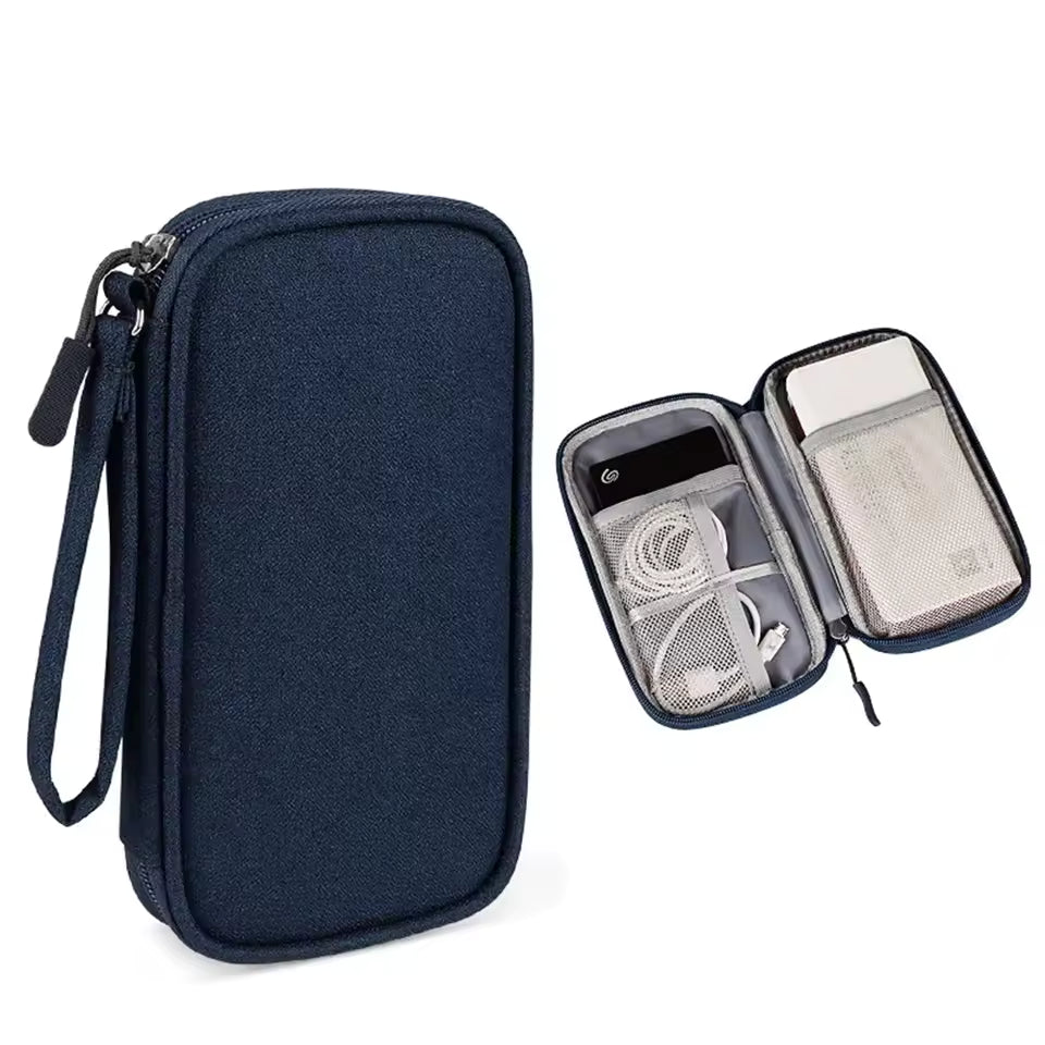 Navy blue travel organizer with compartments for electronic devices on a white background