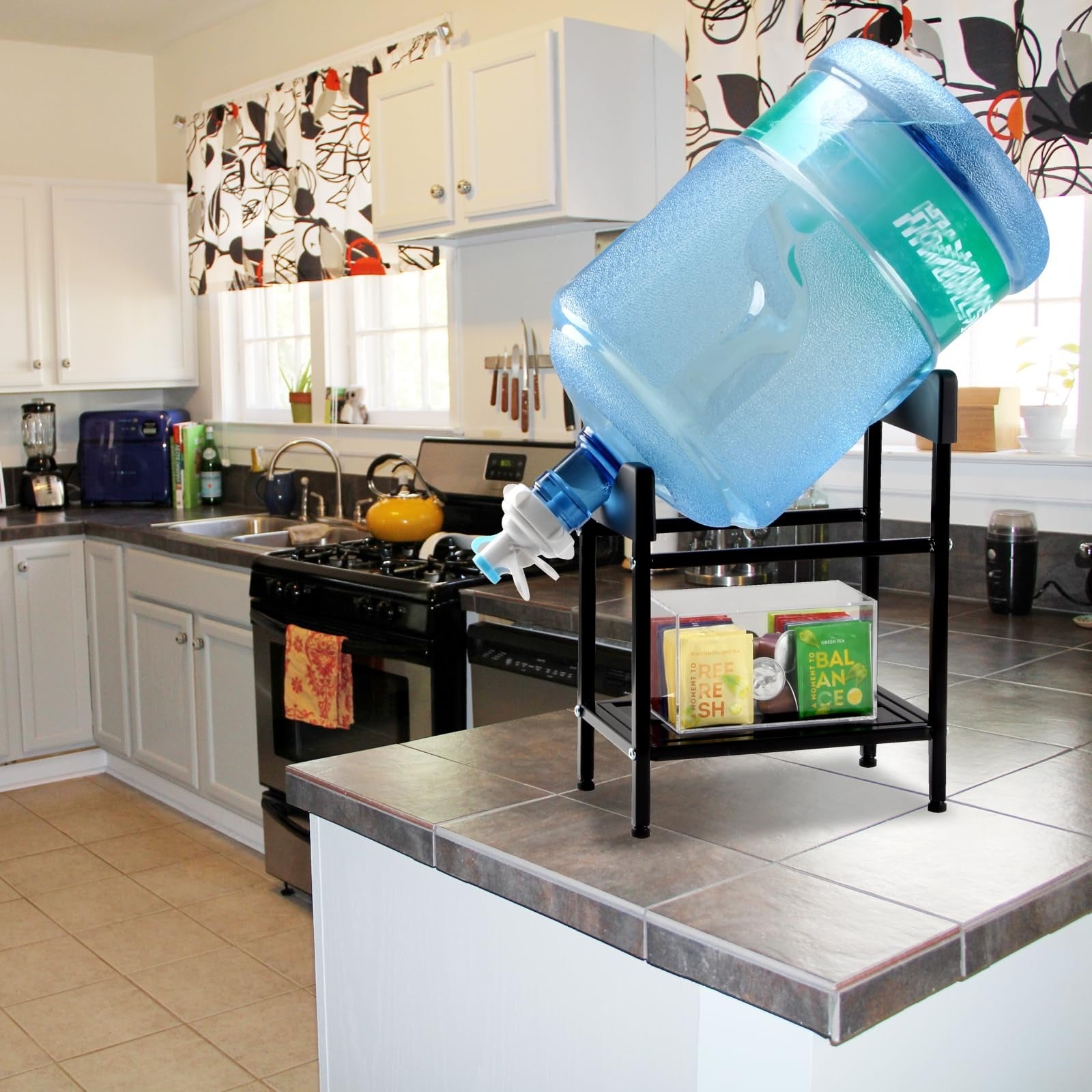 Water dispenser stand with jug on kitchen counter, boxes stored bottom shelf