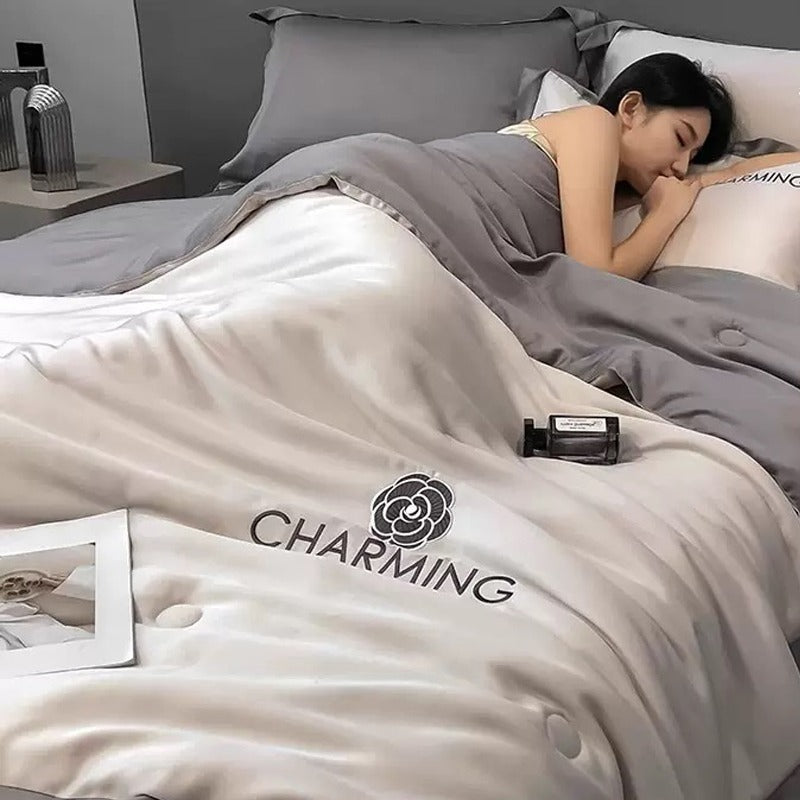 A Woman is Sleeping on Summer Quilted Cooling Comforter Bedding Set.