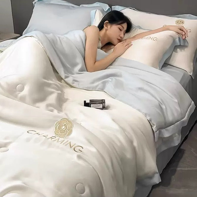 A Woman is Sleeping on Summer Quilted Cooling Comforter Bedding Set.