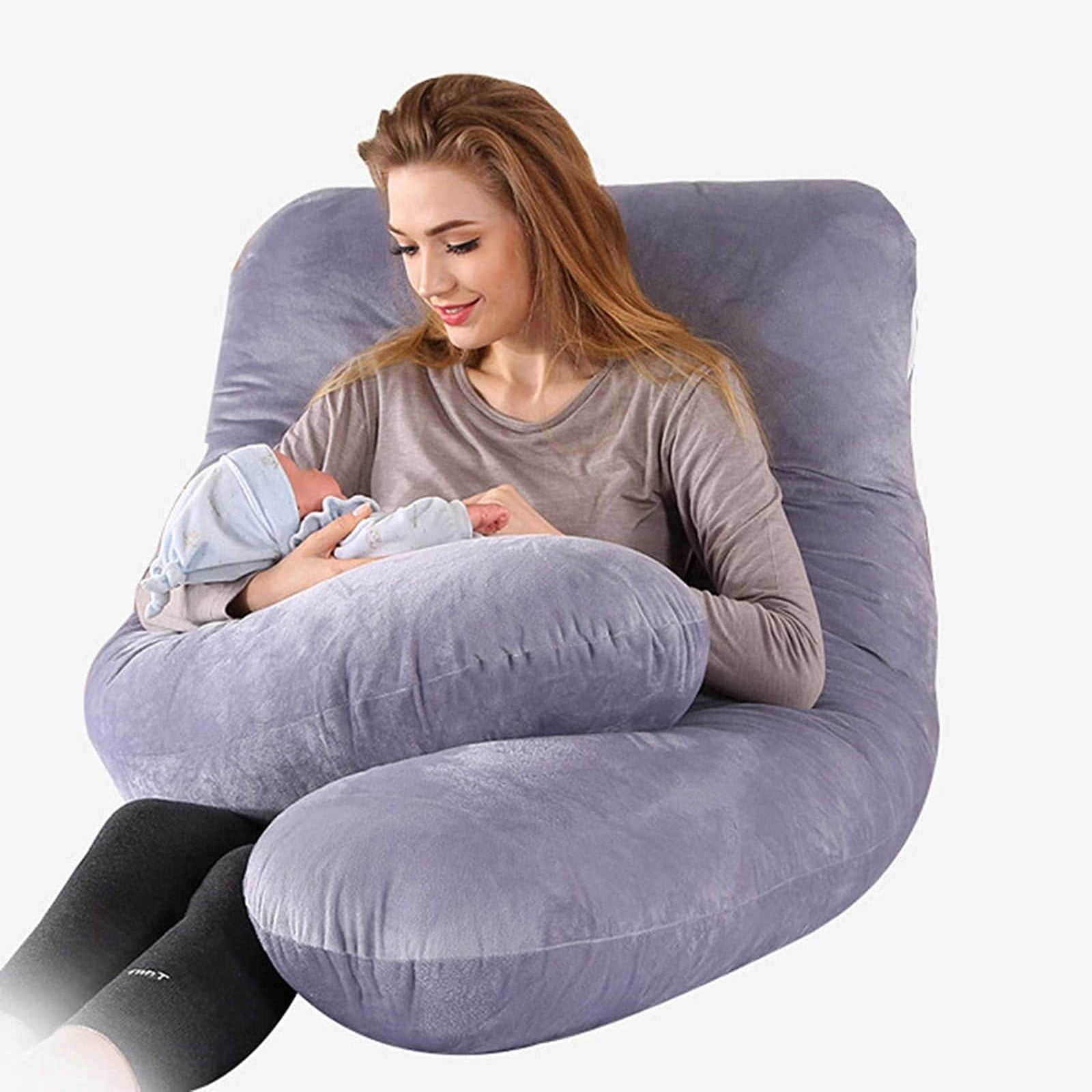 A Woman is Feeding Baby with the Aid of Full Body Pregnancy Pillow.