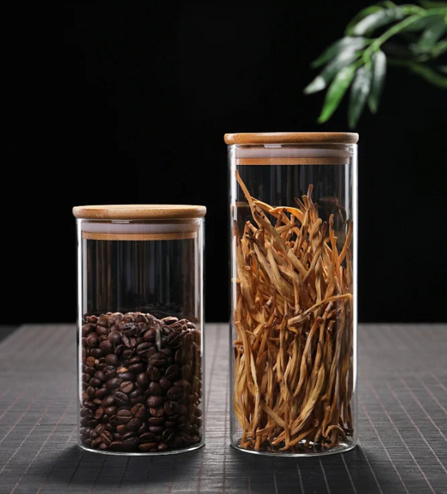 A Set Of Glass Storage Jars are Filled with Spices.