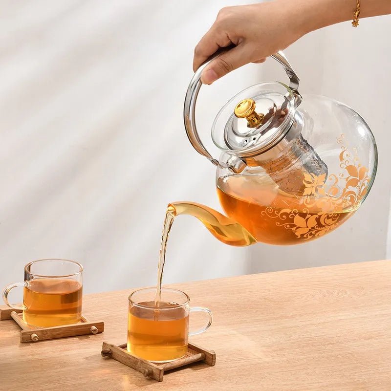 A Person is Pouring Tea from Glass Tea & Coffee Pot.