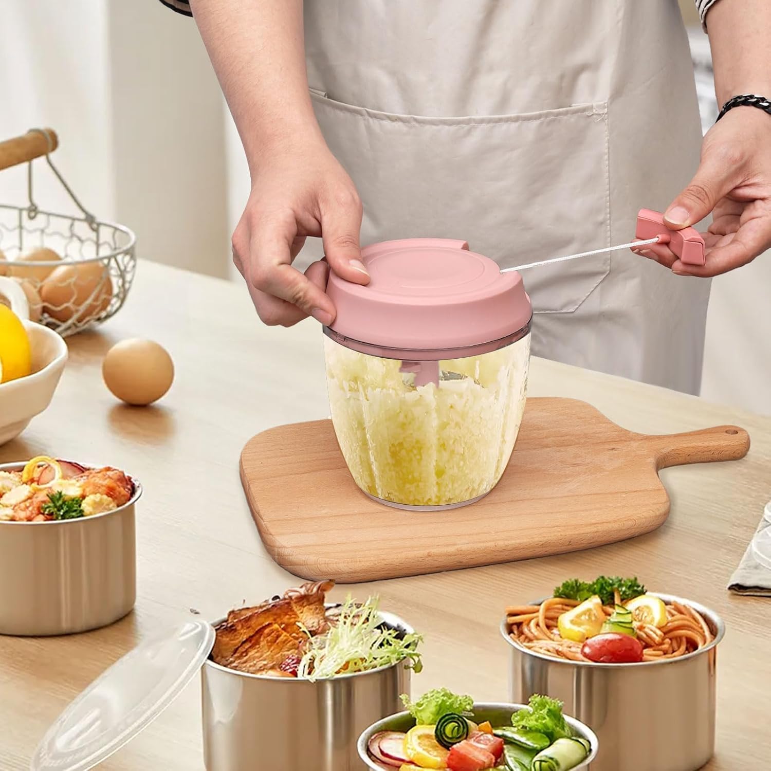 A Person is Using Manual Food Processor to Chop Food Items.