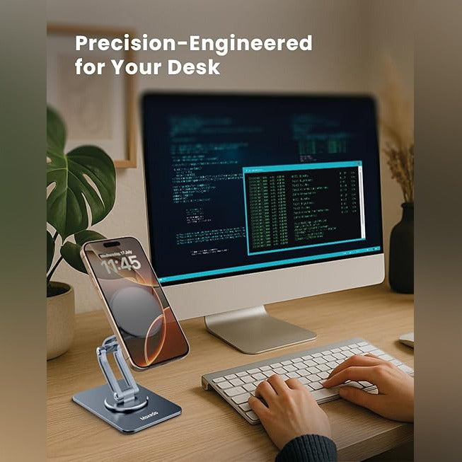 A mobile phone stand is positioned on a wooden desk, holding a smartphone while a person is working.
