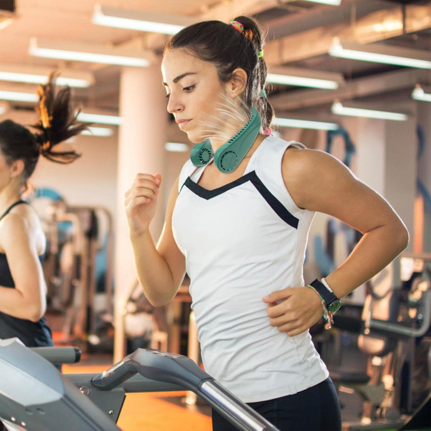 A Woman is Wearing Vaneless Hanging Neck Fan While Excersicing.