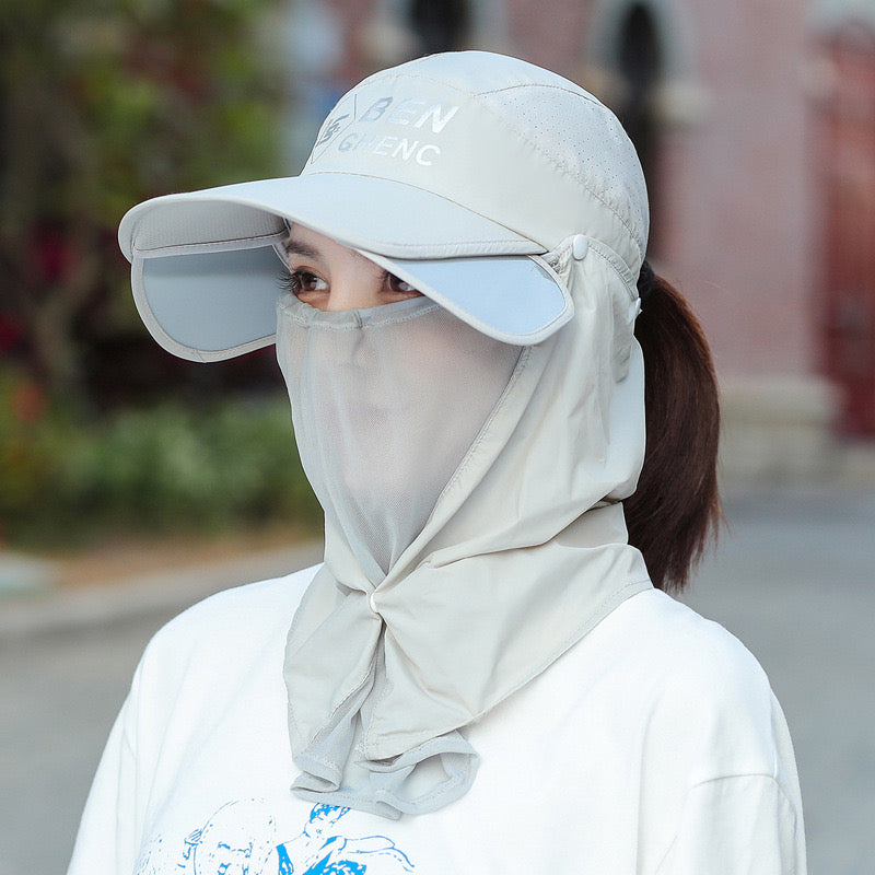 A Woman is Wearing Wide Brim Bucket Hat with Neck Cover.