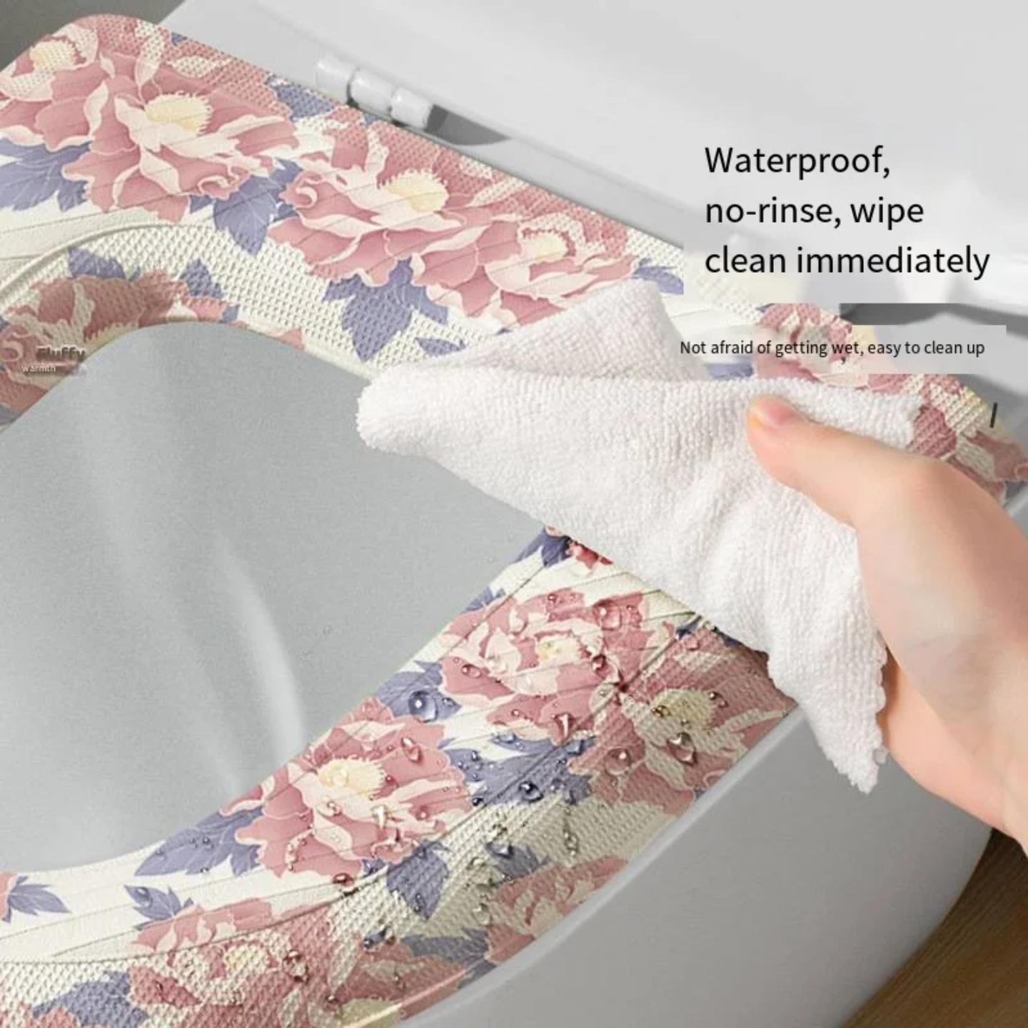 A Person is Wiping Soft waterproof Toilet Seat Cushion Cover, placed on a toilet seat for added comfort and hygiene.