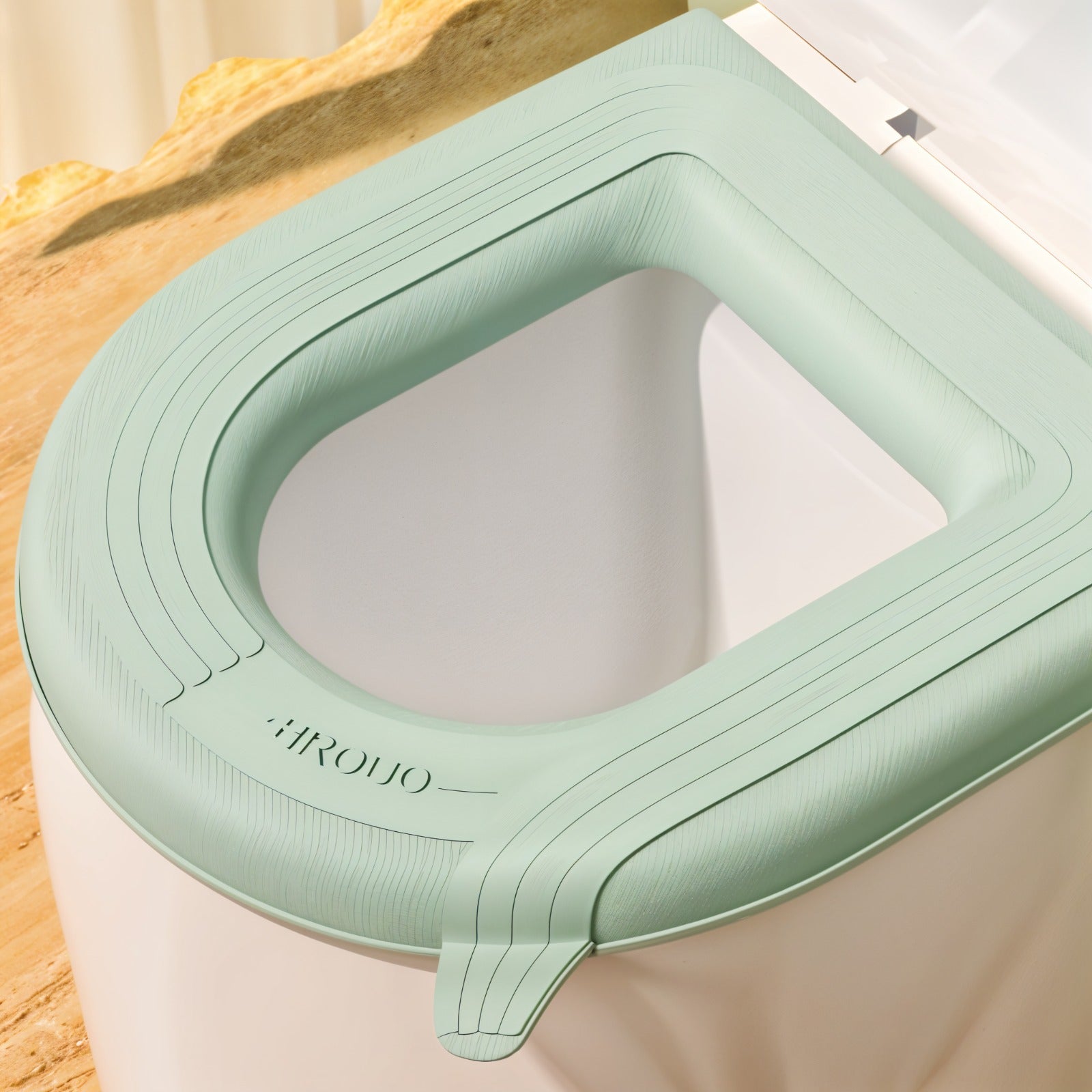 A padded toilet seat cover shown fitted on a toilet.