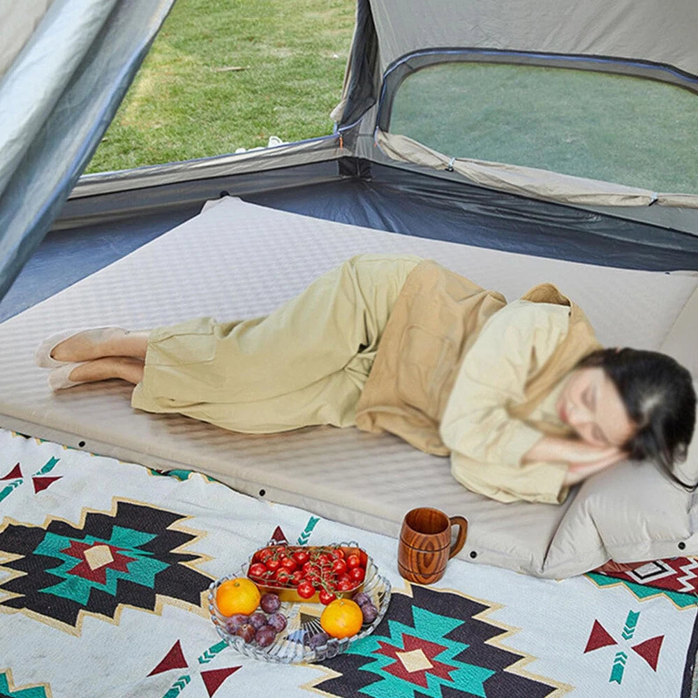 A Person is sleeping inside a camping tent on a self-inflating camping mattress with built-in pillow.