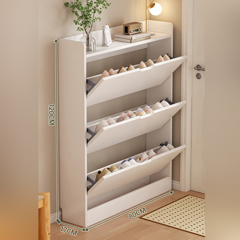 A slim shoe cabinet with flip drawers that neatly stores shoes while saving space, with a top surface for décor or essentials.