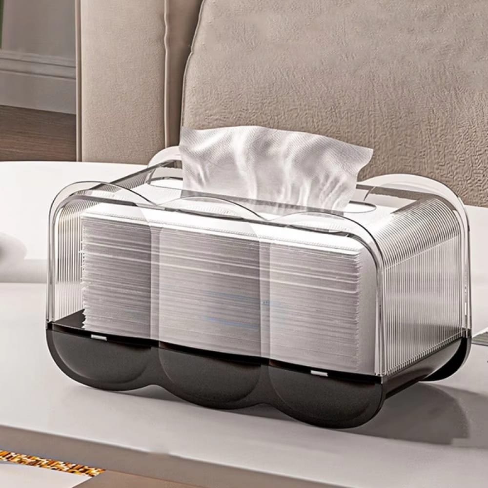Black Wave shaped transparent tissue box on a table,with one tissue pulled up and ready for use.