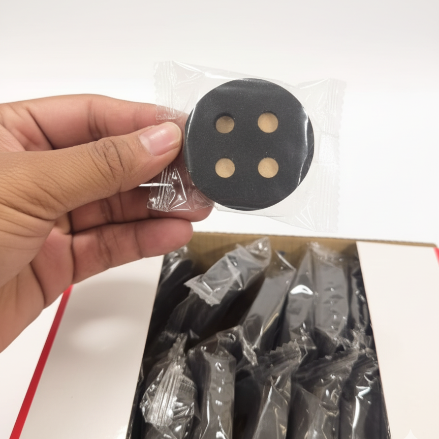 A Person is Holding Quick-Light Charcoal Tablets.