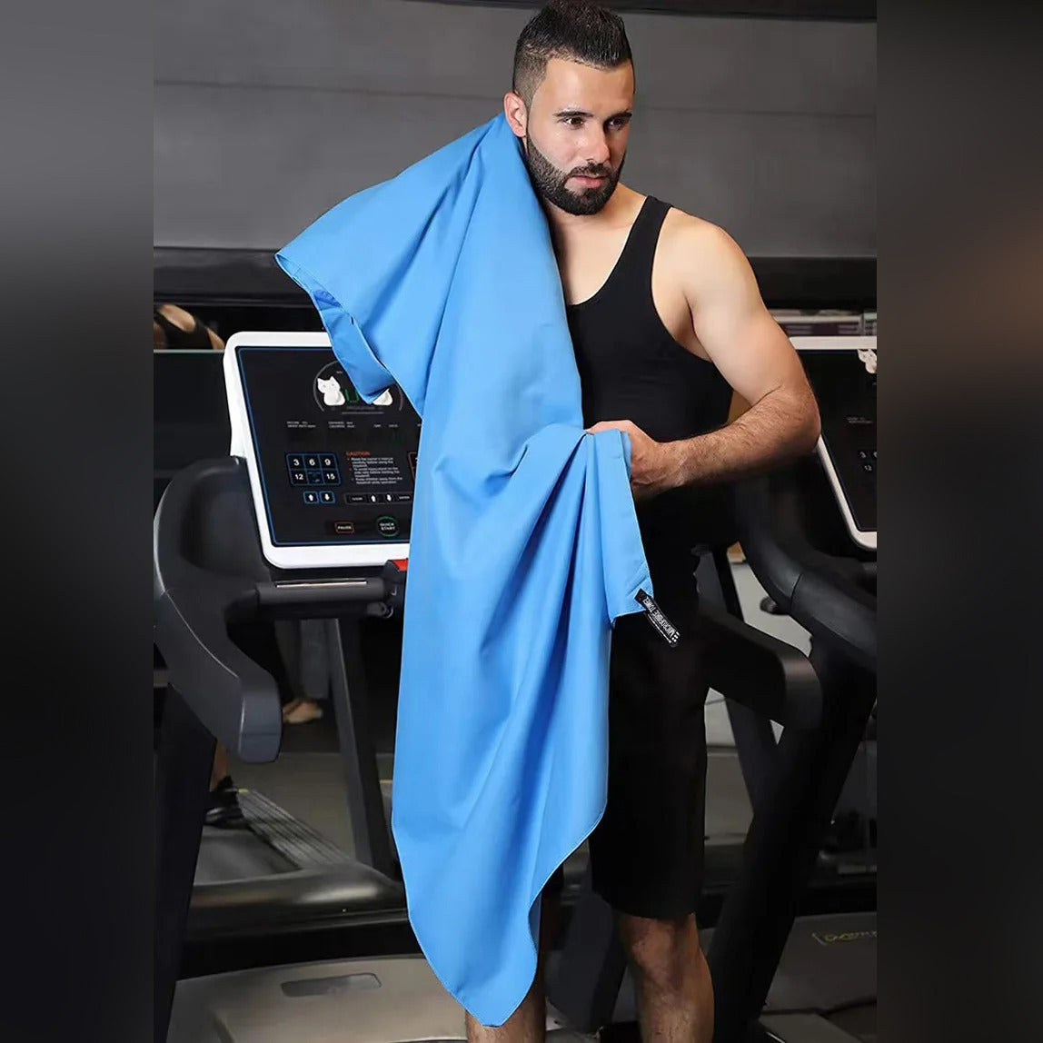 A man is wiping his head with a Quick Dry Microfiber Towel